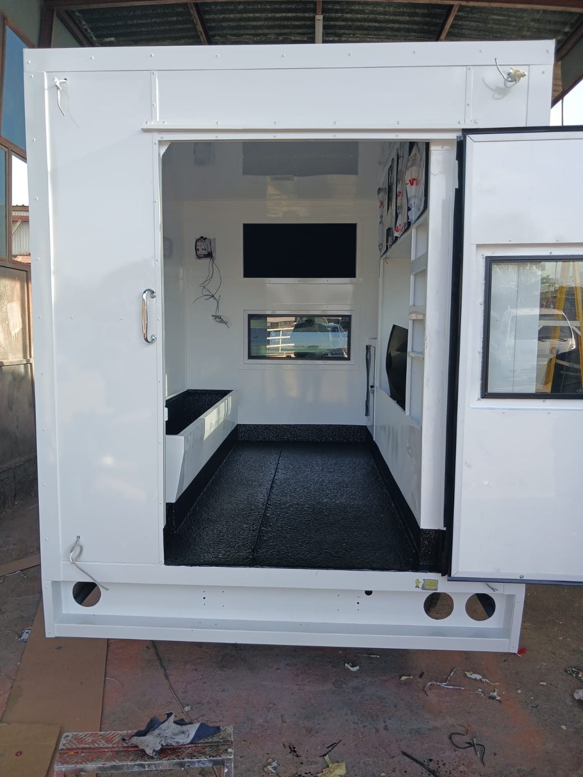 Mobile office unit interior with a black rubberised floor