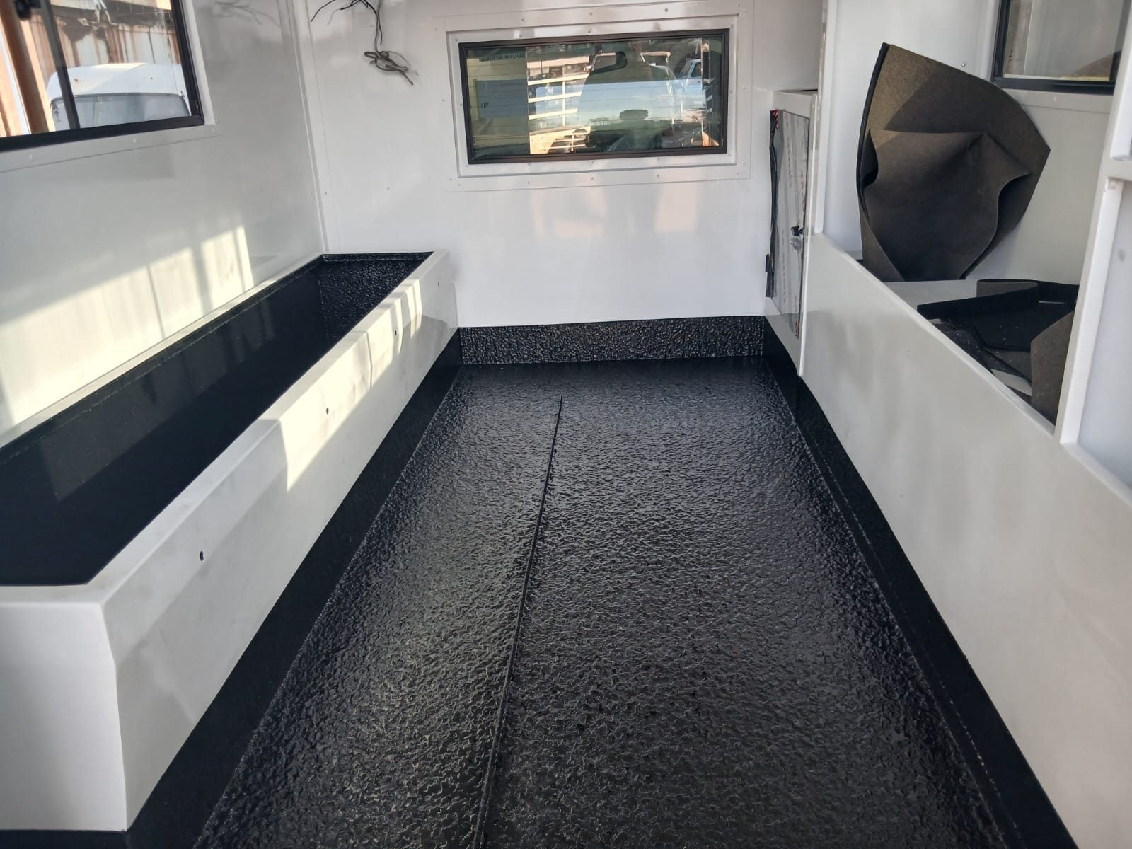 Mobile office unit interior with a black rubberised floor
