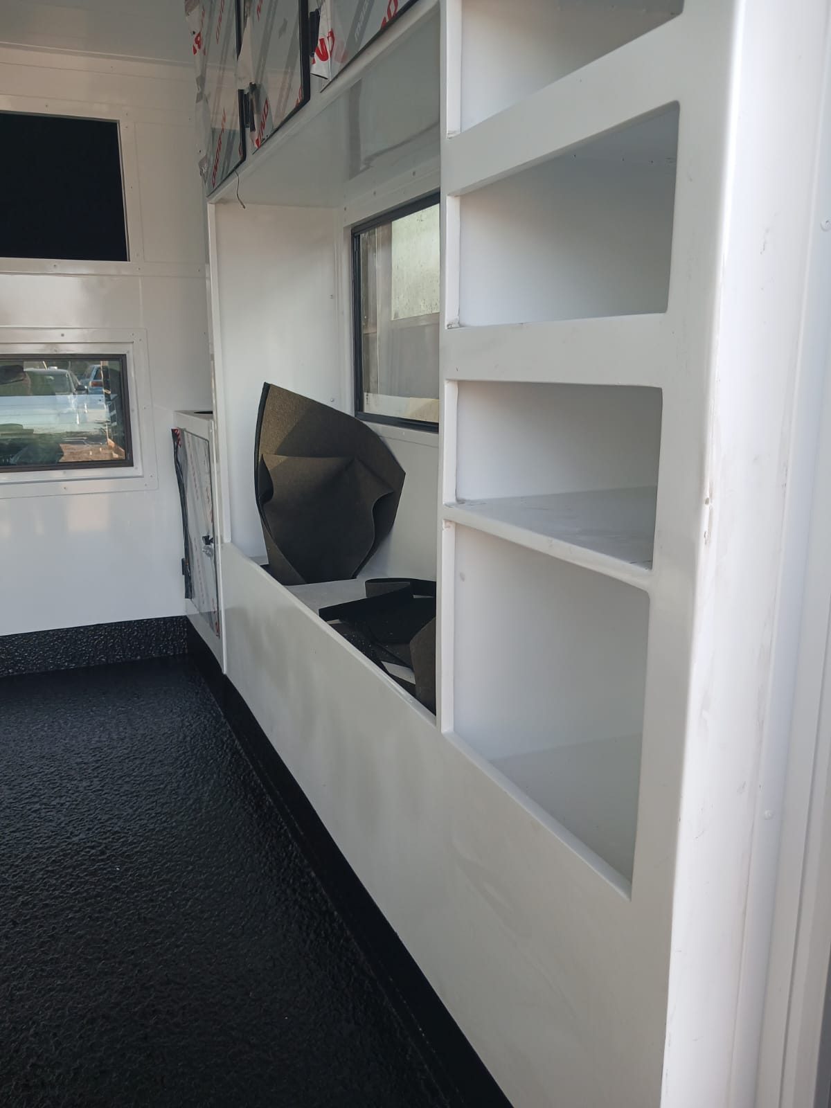 Mobile office unit interior with a black rubberised floor