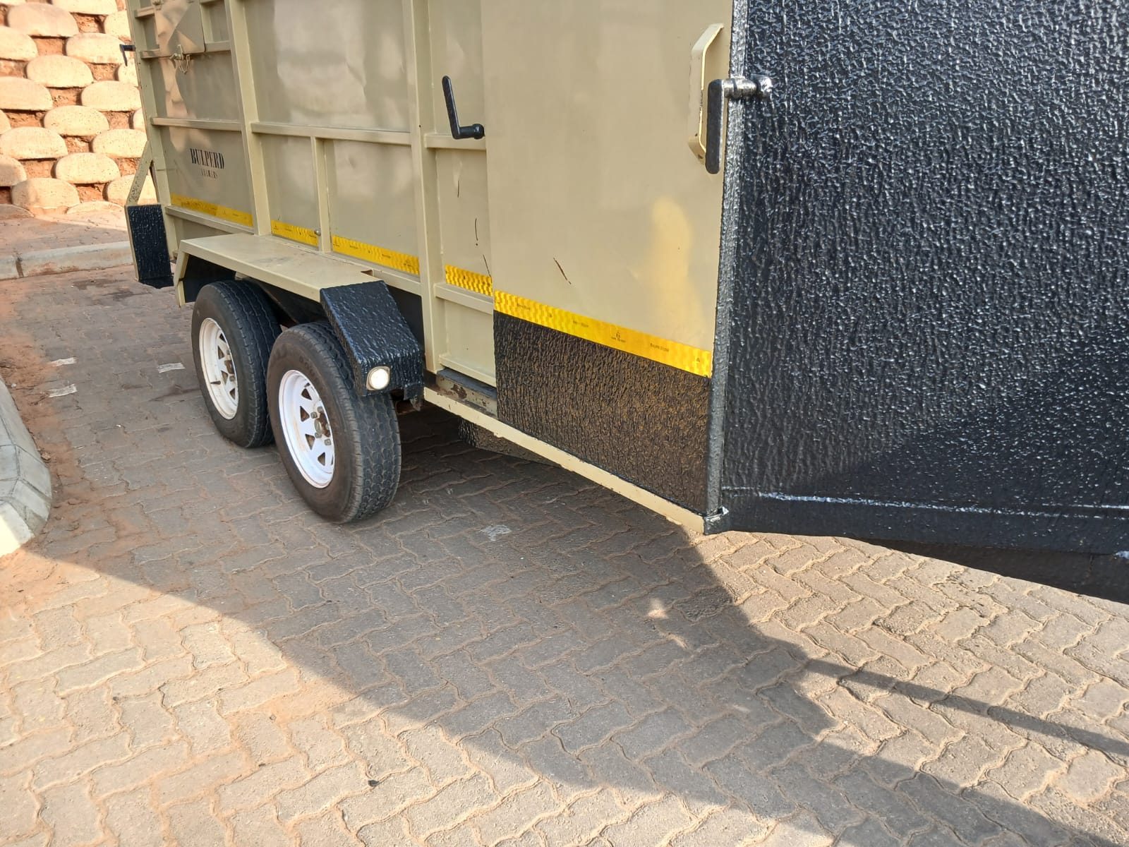 Box trailer, cream body with textured black lower panels