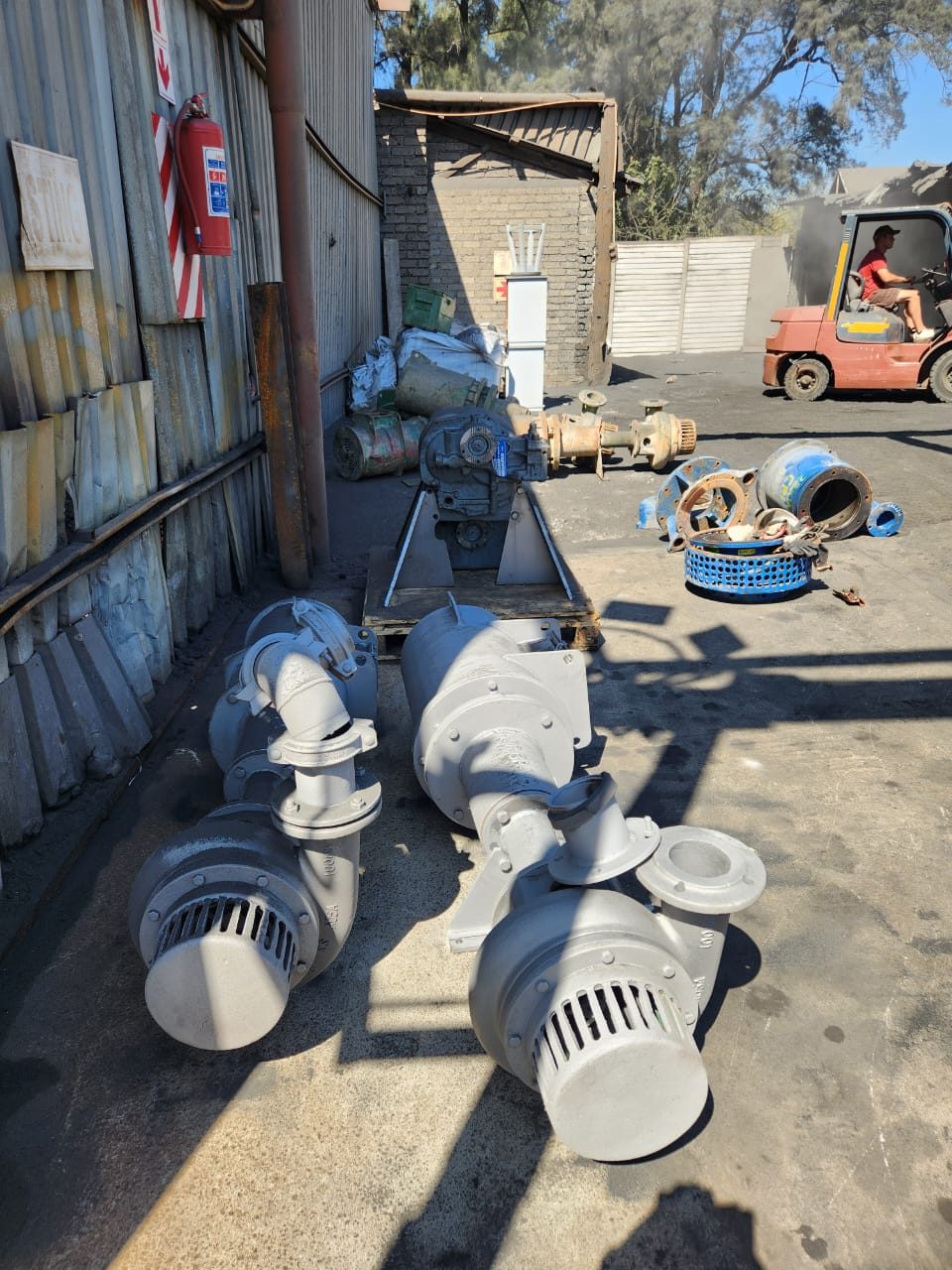 Mining pump and motor sets sandblasted back to bare metal