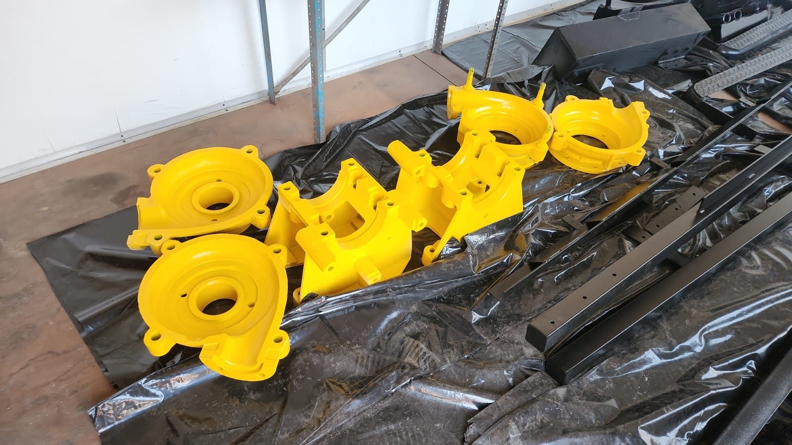 Pump housings and steel sections powder coated yellow and black