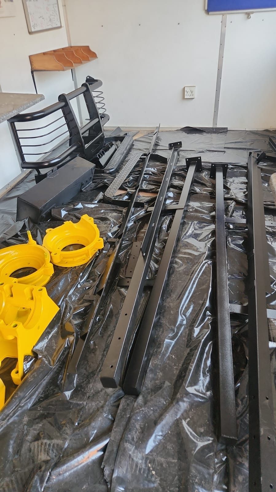 Pump housings and steel sections powder coated yellow and black