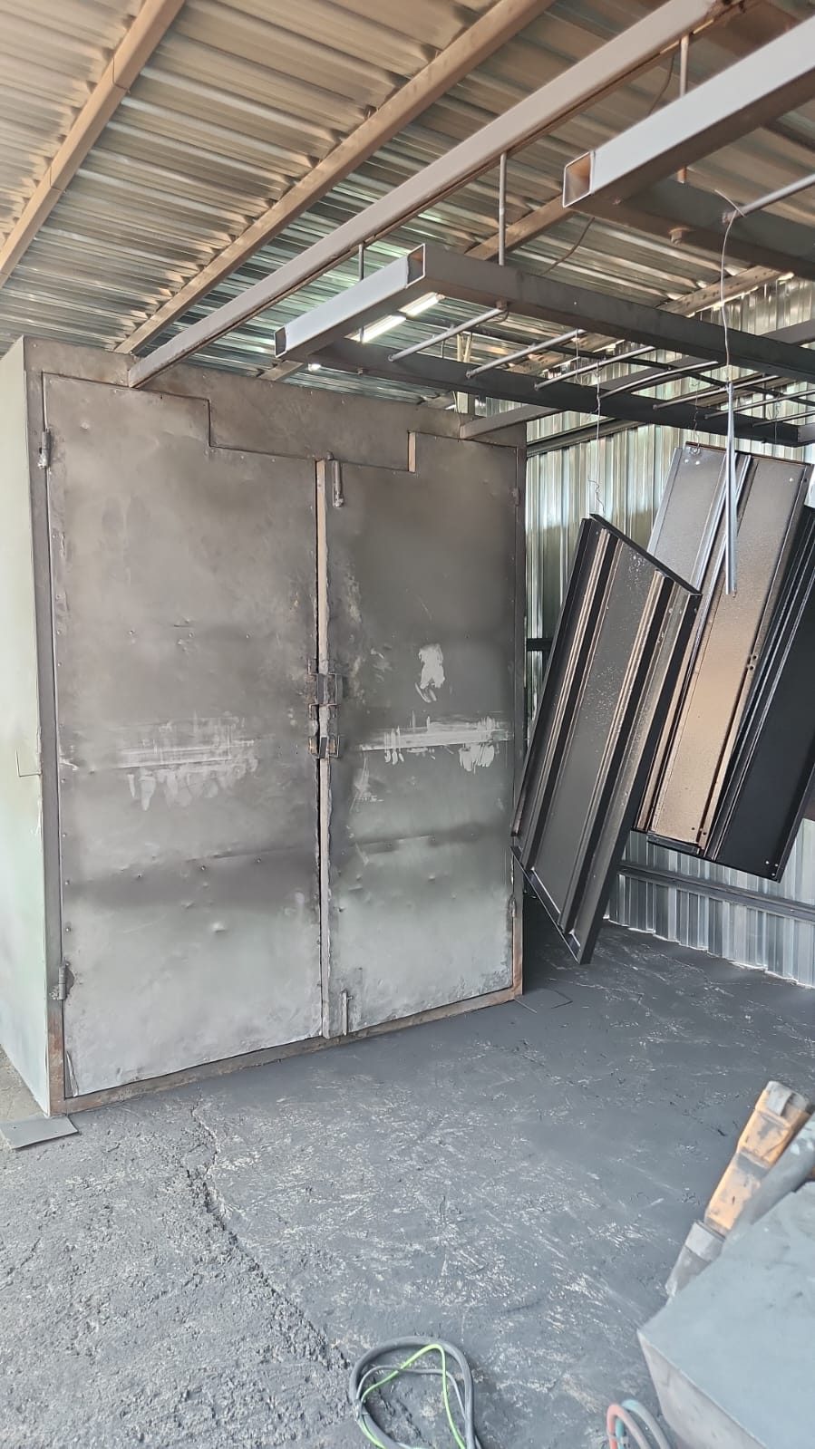Powder coating oven and hanging line in the workshop